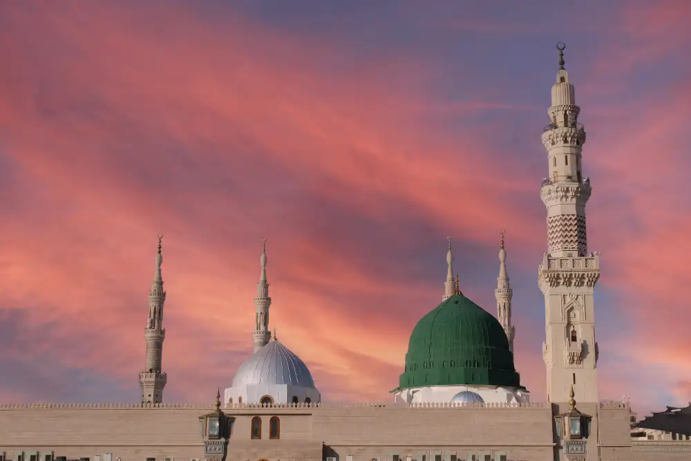The green dome and minarets of Al-Masjid an-Nabawi at sunset